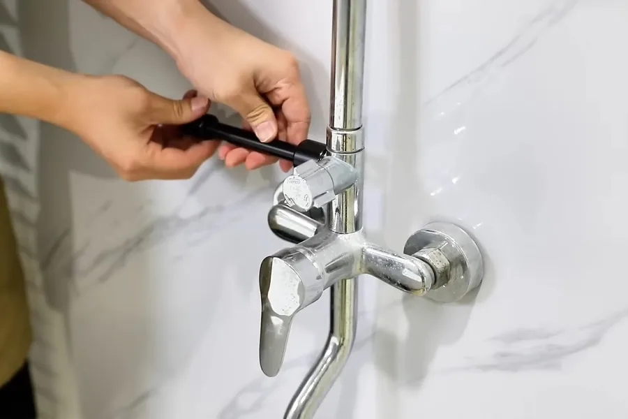 Technician working on a bathtub faucet and drain connection for Shower & Bathtub Plumbing in Fountain Valley, CA in Fountain Valley
